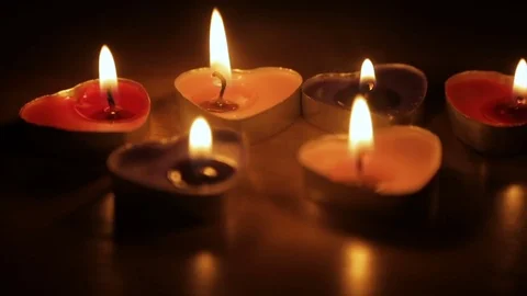 Candles in the shape of hearts are burning in the dark Vídeo Stock 71817351
