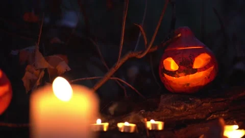Candles shine up small space. Orange spooky pumpkin with cut holes glowing   Stock Footage 139519979