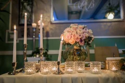 Candles on a table in a restaurant with decor Stock Photos