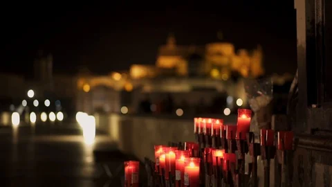 Candles under statue of the Archangel of St. Gabriel on the Roman bridge. Stock Footage