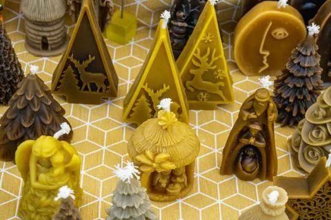 Candles in various shapes arranged on a patterned surface showcasing winter.. Stock Photos