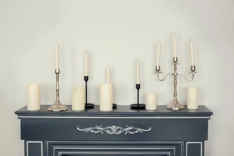 Candles of various types and sizes with and without candlesticks fireplace Stock Photos