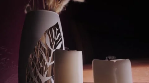 Candles of white color stand on table and fade from blow Video stock 196061614