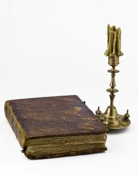 Candlestick and a book Photos