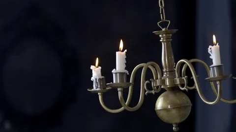 Candlestick with burning candles moves Stockbeeldmateriaal 72300043