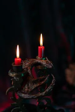 Candlestick with candles in the shape of a dragon Stock Photos