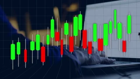 Candlestick chart moving over laptop as hand tapping keys causing candles rising Stock Footage 334703646