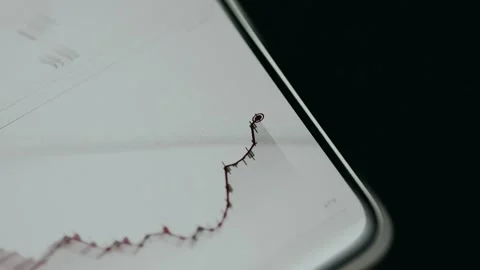 Candlestick chart with an overlaid red trend line and a glowing data point Stock Footage 334939038