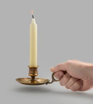 Candlestick with flame lights and hand (clipping path) Stock Photos