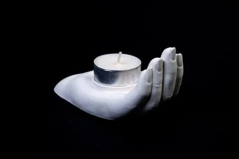 Candlestick in the form of a plaster hand with candles, a plaster candlestick Stock Photos