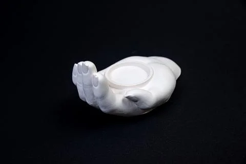 Candlestick in the form of a plaster hand with candles, a plaster candlestick Stock Photos