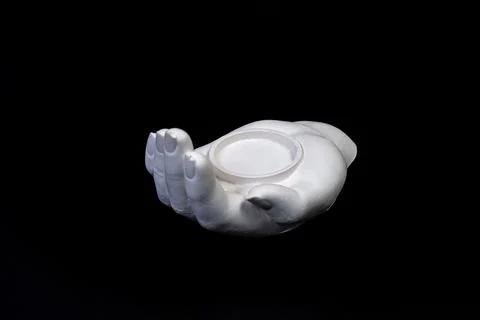 Candlestick in the form of a plaster hand with candles, a plaster candlestick Stock Photos