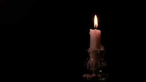 Candlestick holder with burning candle flame on black background, copy space, 4K Stockbeeldmateriaal 143948824