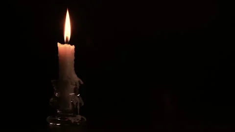 Candlestick holder with burning candle flame on black background, copy space, 4K Stock Footage 144302392