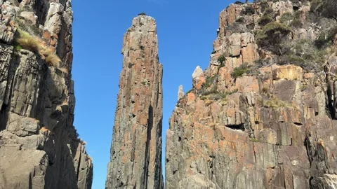 The Candlestick sea stack between dolerite cliffs at Cape Hauy Stock Footage 347437817