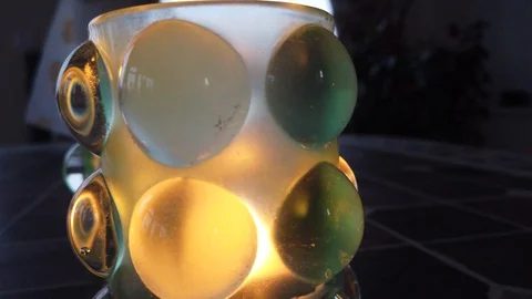 Candlestick vase that glows around fast film Stock Footage 122360413