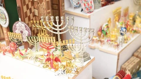 Candlesticks for seven candles of different sizes puts on counter in market. Stock Footage 183991105