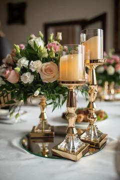 Candlesticks on the table next to the flowers Foto stock