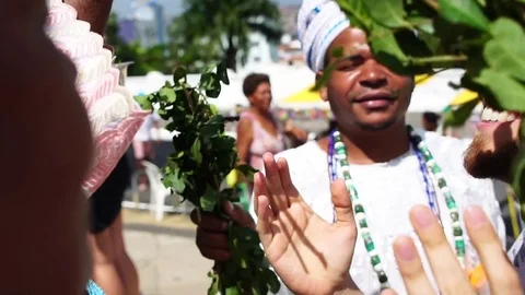 Candomble group wearing traditional clothes at Bonfim Church blessing a tourist Stock Footage