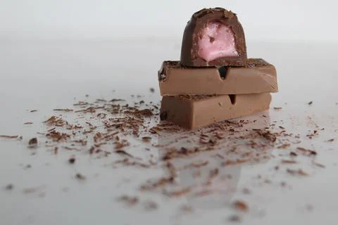 Candy and chocolate lie a stack of slides on a white background with a place Stock Photos