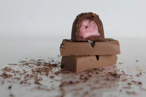 Candy and chocolate lie a stack of slides on a white background with a place Stock Photos