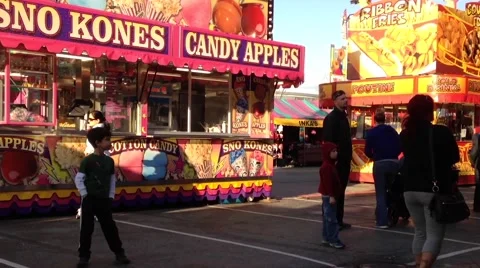 Candy apples booth at Coast Amusements Carnival Stock Footage 54944229
