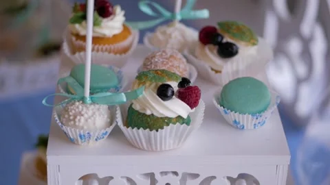 Candy bar in the banquet hall. Candy buffet. Cupcakes on the table. Stock Footage 105194884