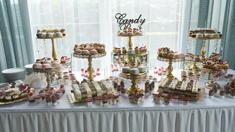 Candy bar. Buffet with delicacies at the wedding. Confectionery. Macaroons Stock Footage 142522897