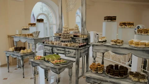 Candy bar. Buffet with delicacies at the wedding. Confectionery. Macaroons Stock Footage 179955239