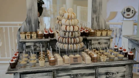 Candy bar. Buffet with delicacies at the wedding. Confectionery. Macaroons Stock Footage 179955711