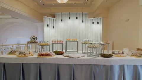 Candy bar. Buffet with delicacies at the wedding. Confectionery. Macaroons Stock Footage 179956211