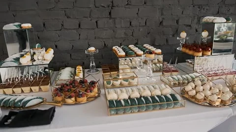 Candy bar. Buffet with delicacies at the wedding. Confectionery. Macaroons Stock Footage 196081258