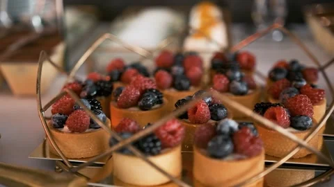 Candy bar. Buffet with delicacies at the wedding. Confectionery. Macaroons Stock Footage 196084794