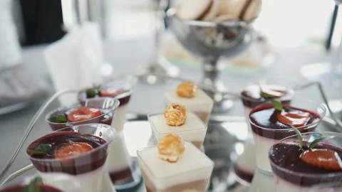 Candy bar. Buffet with delicacies at the wedding. Confectionery. Macaroons Stock Footage 196876888