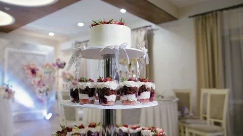 Candy bar, cake with trifles, decorated with white cream with berries Stock Footage 125005133