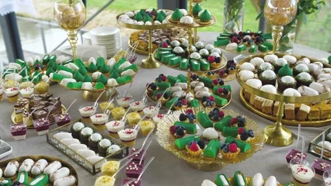 Candy bar, Sweets on stands. Delicious desserts at the banquet, sponge cakes Stock Footage 267681635