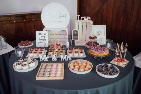 Candy bar. Table with different sweets for party Stock Photos