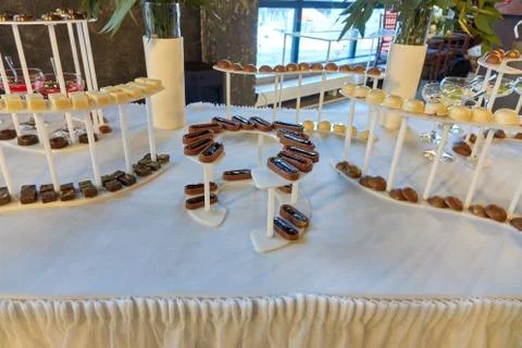 Candy bar on the white table with a different kunds of sweets and other desse Stock Photos