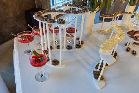 Candy bar on the white table with a different kunds of sweets and other desserts Stock Photos