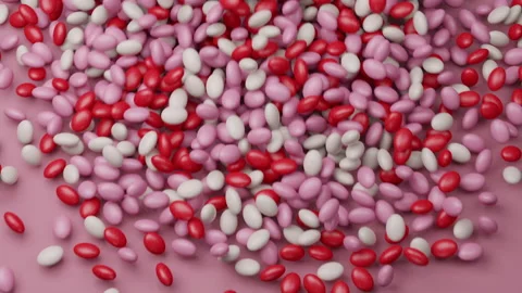 Candy beans or peanuts dynamic footage. Red, pink, white colored sugar sweets Stock Footage 156130380