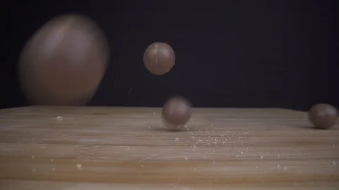 Candy bouncing on wooden table in slowmotion macro closeup Stock Footage 124018229