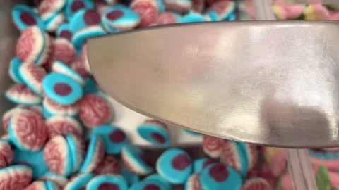 Candy brain scoop Banner with moving jelly candies in shape of skull, eye, jaw Stock Footage 314097800