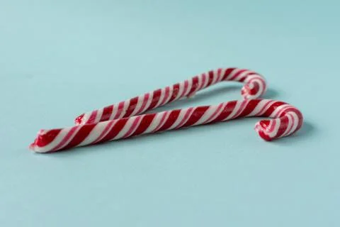 Candy candy cane on a blue background. Symbol of the new year. Children's swe Stock Photos