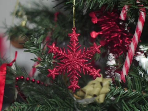 Candy cane and red Christmas glittering ster 5.8K tilting video Stock Footage 299977824