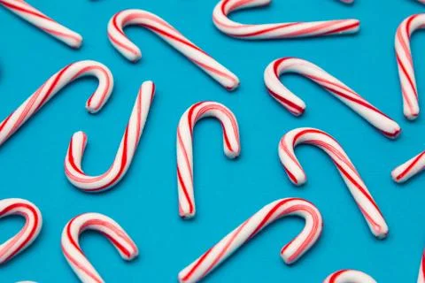 A Candy Cane Background on a Blue Background Stock Photos