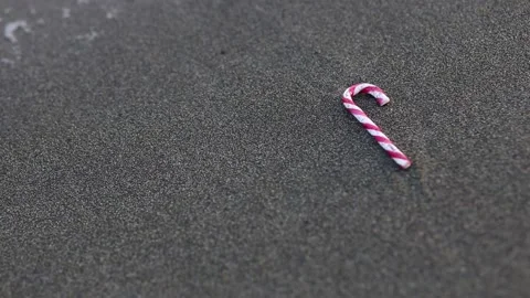 Candy cane on the beach Stock Footage 132518635