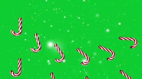 Candy cane falling on green Christmas snowfall background Stock Footage 250629353