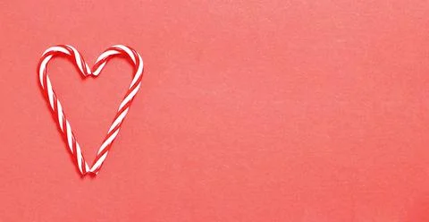 Candy cane heart on red background with copy space Stock Photos