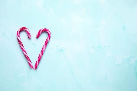 Candy cane making a heart on a light blue background, Candy cane heart Christmas Stock Photos