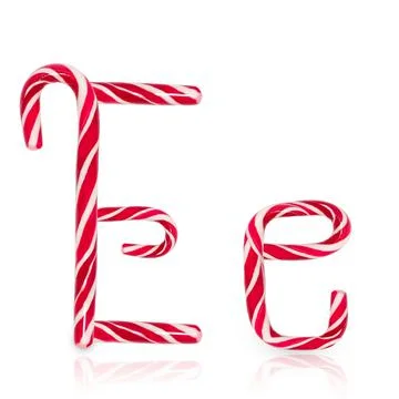 Candy cane in shape of letter E isolated on white background. Stock Photos